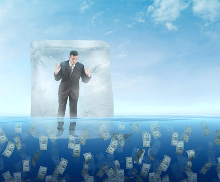 Ice cube with a businessman  floating in the sea of money