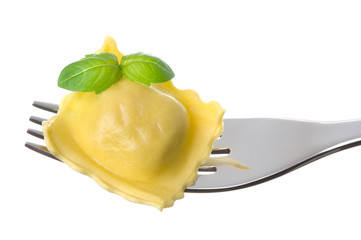 ravioli pasta parcel and basil garnish on fork white background