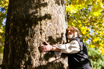 old man hugging a tree