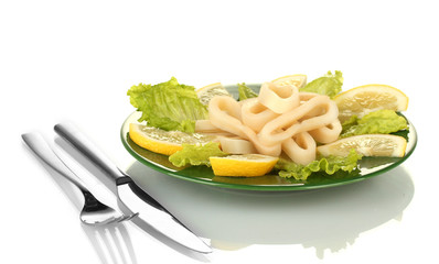 salad of squid rings, lemon and lettuce in the plate isolated
