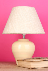 table lamp and book on pink background