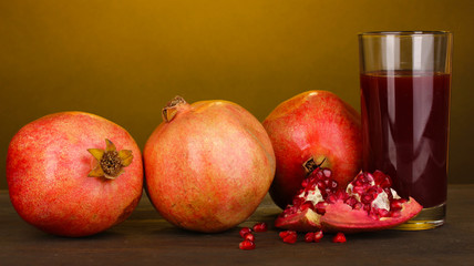Fototapeta na wymiar Ripe pomegranates with glass of pomegranate juice
