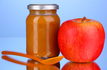 Useful and tasty baby food with apple and spoon