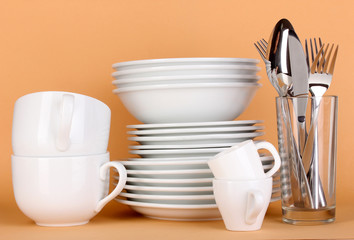 Clean white dishes on beige background