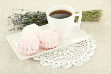 Marshmallows on plate on light background