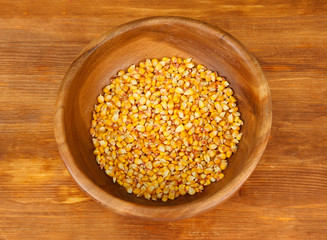 Corn in wooden bowl  on wooden background