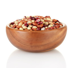 Wooden bowl with beans isolated on white