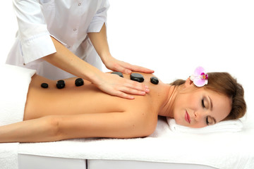 Fototapeta premium beautiful woman in spa salon with spa stones getting massage,