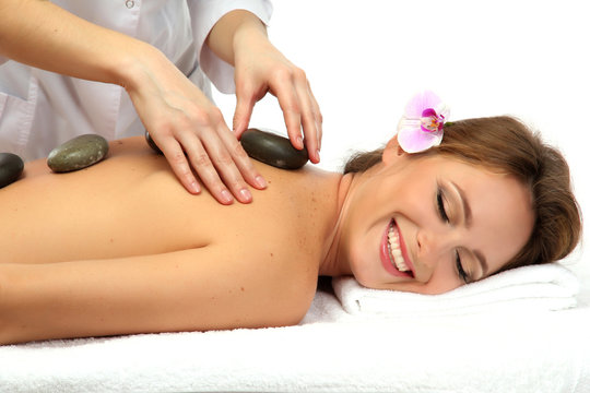 beautiful woman in spa salon with spa stones  getting massage,