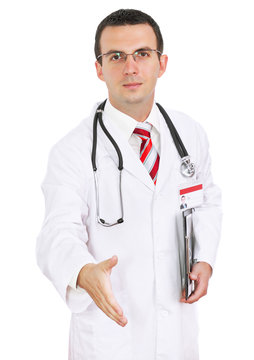 Portrait of doctor ready for handshake. Isolated.