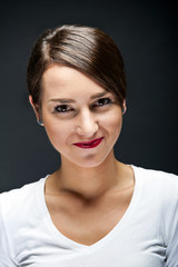 Woman with sensual smile on black background