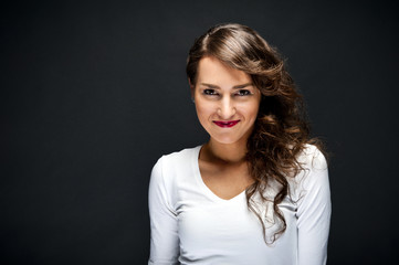 Obraz premium Woman with sensual smile on black background