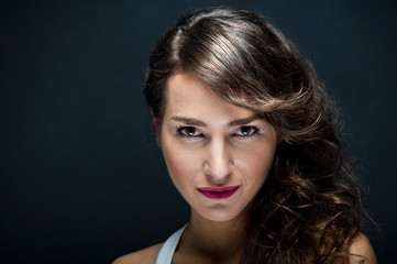 Woman with sensual smile on black background