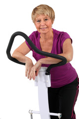 senior woman doing exercises in the gym