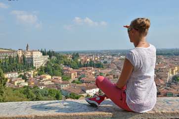 Fototapeta na wymiar Girl looking to Verona town, Italy