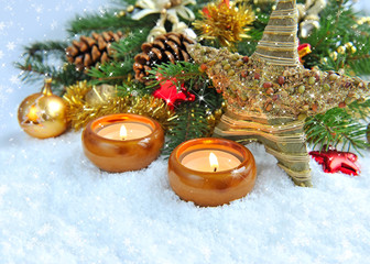 Christmas background is with candles on snow