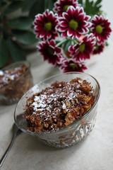 Still life with bowl with oatmeal nuts desert and flowers