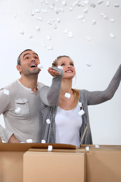 couple making polystyrene chips fly