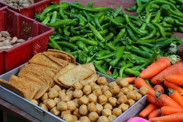 Fresh vegetables and tofu in a Chinese market.