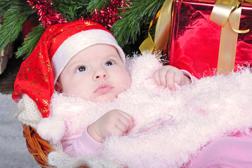 the little girl under the Christmas tree on new year's cap