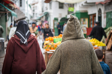 Moroccan people in traditional Djellaba and burqua clothes