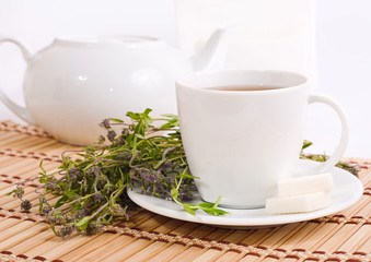 cup of herbal tea and teapot