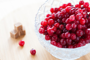 Cranberries in a transparent bowl with sugar