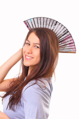 Smiling young woman with a fan