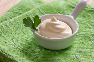 Mayonnaise in bowl on table