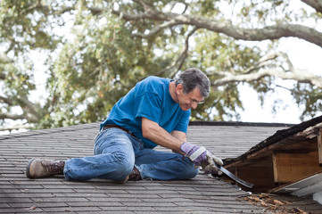 Man Repairing Leaking Roof - 47639914