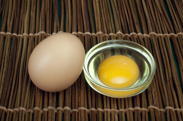 Broken in half raw egg and yolk inside