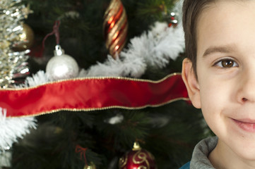 Happy children in front of Christmas tree