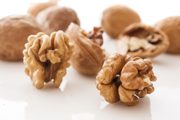 walnut and a cracked walnut on white background