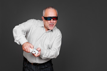 senior man in 3d glasses playing in video game