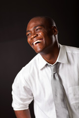 laughing african american man over black background
