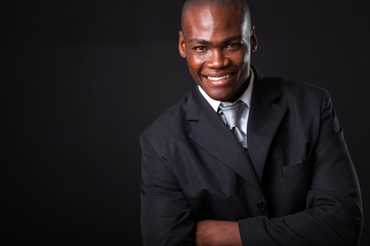 handsome african american businessman on black background