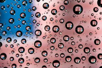 Reflection of United States of America flag on water droplet