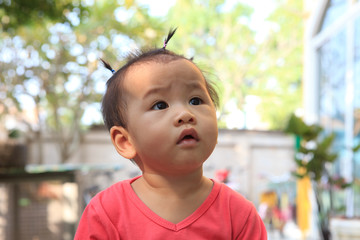 head shot of asian baby sitting on home terrace