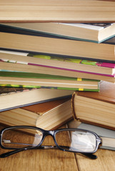 Reading glasses on the opened book