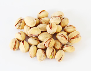 Handful of roasted salted appetizing pistachios on white