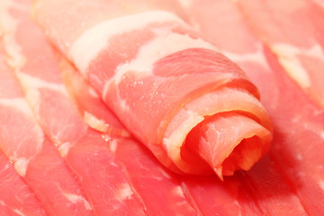 Close up of twisted thin piece and row of chunks of smoked red