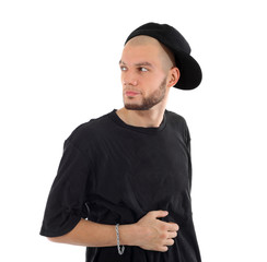 Rapper wearing black t-shirt and hat looks into distance