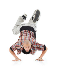 Breakdancer stands on hands and looks at camera isolated