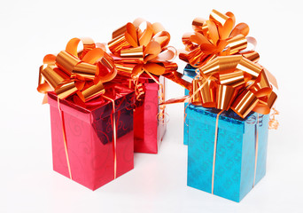 Four red and blue shiny gift boxes with beautiful orange bows.