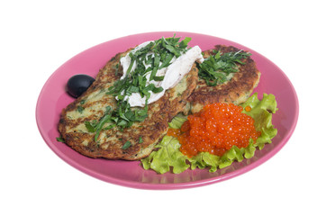 Roasted cutlets of potato with salmon on a plate