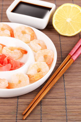 Prawns on plate with chopsticks and sauce