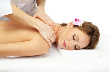 Obraz na płótnie Canvas beautiful woman in spa salon getting massage, isolated on