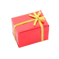Red gift box and golden ribbon on white background.