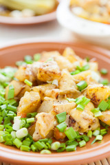 baked potato with cheese and green onions
