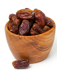 dried dates in a wooden bowl